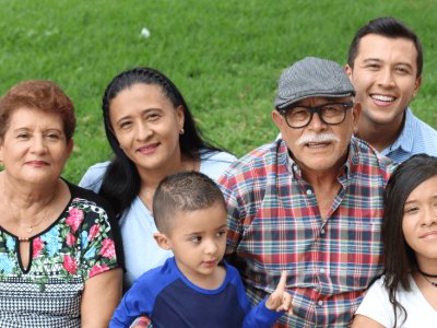 Multigenerational family smiling for immigration DNA testing for U.S. embassy cases.